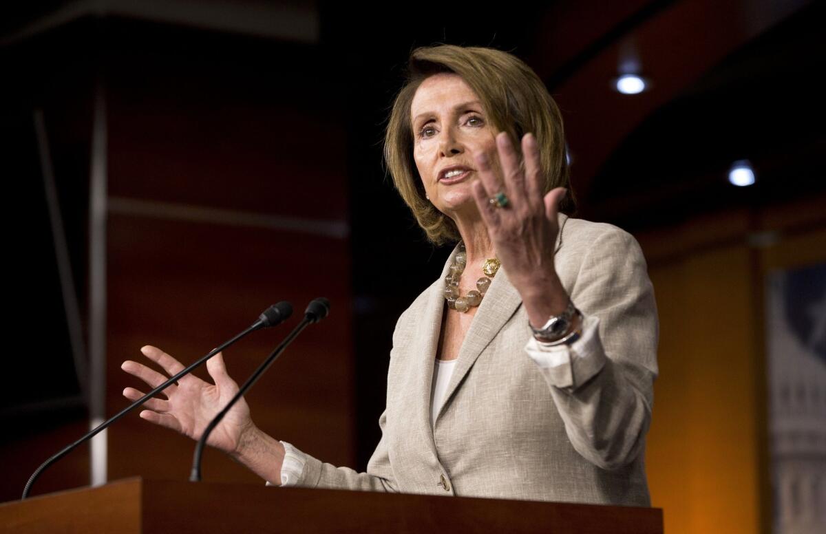 House Speaker Nancy Pelosi speaks at a lectern. 