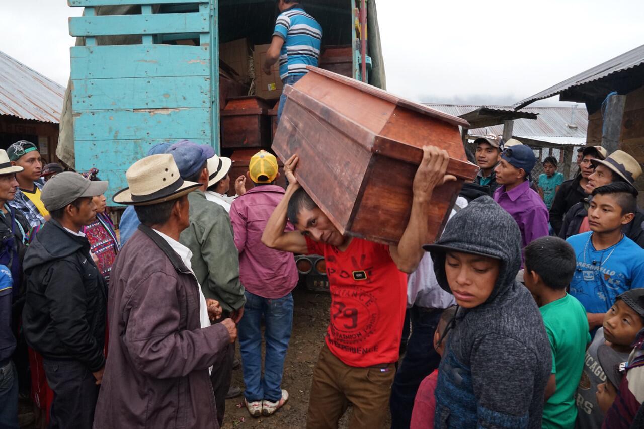Empty coffins are unloaded in Ixtupil, Guatemala, that will be used to rebury the remains of 47 of the Ixil Maya indigenous group from the village that were killed during Guatemala's military rule in the 1980s.