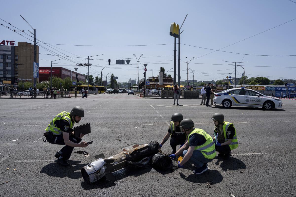 Ukrainian police officers inspecting fragment of Russian rocket