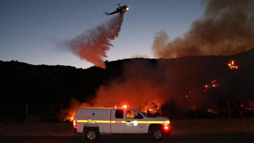 Firefighters in Riverside County battle the Jameson Fire Sunday.