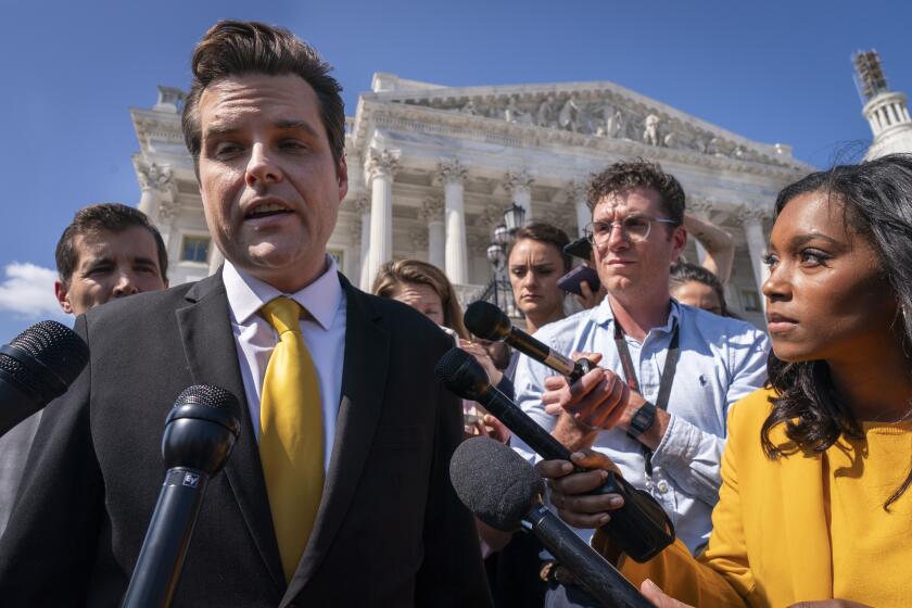 Rep. Matt Gaetz, R-Fla., left, one of House Speaker Kevin McCarthy's harshest critics, answers questions from members of the media after speaking on the House floor, at the Capitol in Washington, Monday, Oct. 2, 2023. Gaetz has said he plans to use a procedural tool called a motion to vacate to try and strip McCarthy of his office as soon as this week. (AP Photo/Jacquelyn Martin)