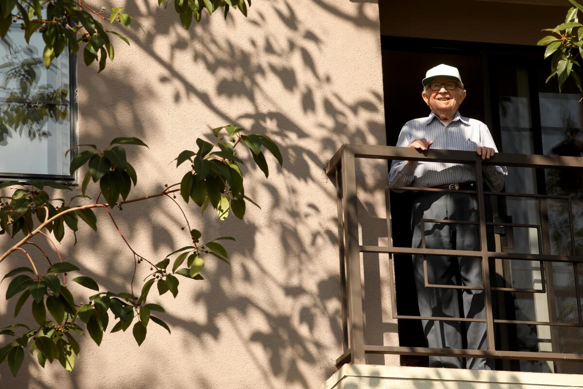 Joe Goldfarb, 103, stands on the balcony of his apartment at the Palm Court retirement home in Culver City .  