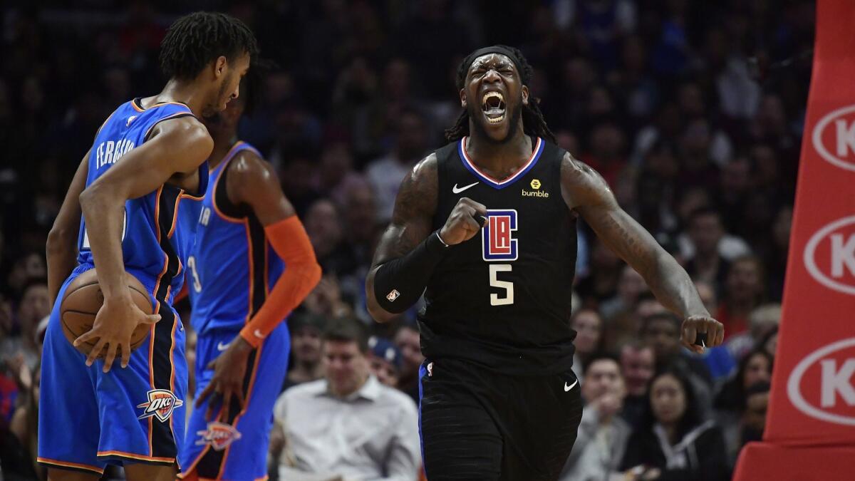 Clippers forward Montrezl Harrell, right, celebrates after scoring and drawing a foul as Oklahoma City Thunder guard Terrance Ferguson, left, stands by during the second half.