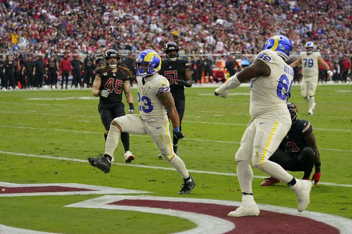 The Rams' Kyren Williams celebrates one of his two touchdowns against the Cardinals.