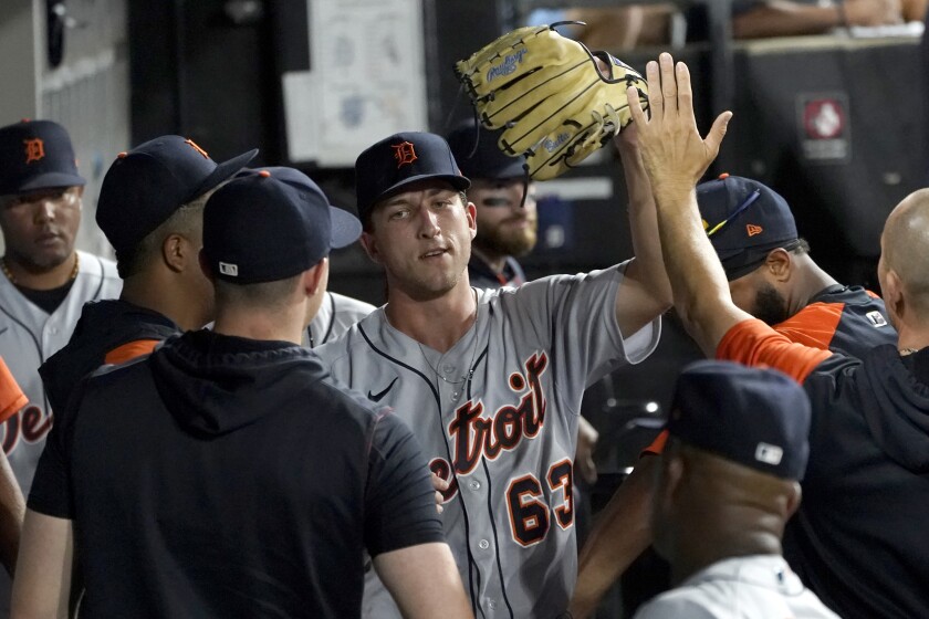 Detroit Tigers starting pitcher Beau Brieske is congratulated in the dugout after being pulled during the seventh inning of a baseball game against the Chicago White Sox Thursday, July 7, 2022, in Chicago. (AP Photo/Charles Rex Arbogast)
