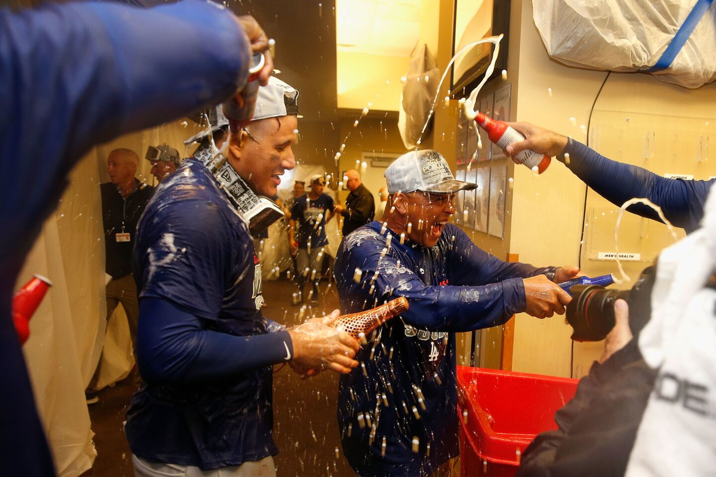 SAN FRANCISCO, CA - SEPTEMBER 29: Manny Machado #8 of the Los Angeles Dodgers and Manager Dave Roberts #30 celebrate after the Dodgers clinched a post season spot by defeating the San Francisco Giants at AT&T Park on September 29, 2018 in San Francisco, California. (Photo by Lachlan Cunningham/Getty Images) ** OUTS - ELSENT, FPG, CM - OUTS * NM, PH, VA if sourced by CT, LA or MoD **