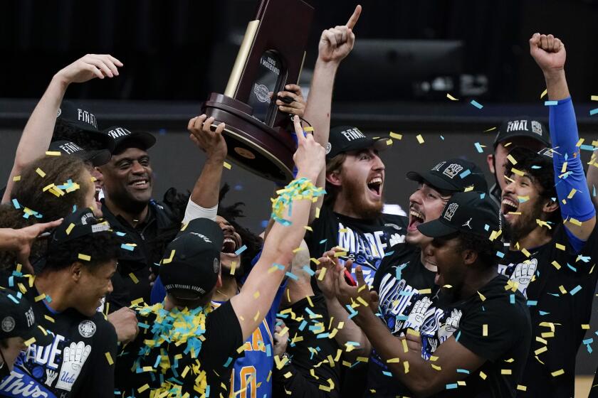 UCLA players celebrate after an Elite 8 game against Michigan