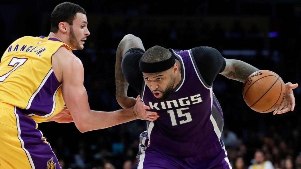 Sacramento Kings' DeMarcus Cousins, right, drives past the Lakers' Larry Nance Jr. on Feb. 14.
