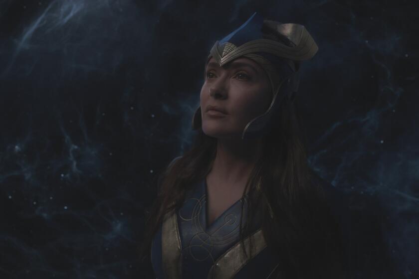 a woman in a blue superhero suit and headpiece