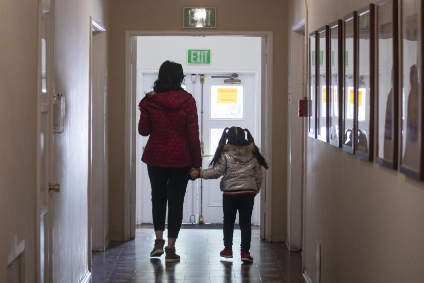 GLENDALE, CALIF. - MARCH 17: Zara Hovhannisyan, Case Manager and her daughter, Victoria Ghukasyan 5 years old visit YWCA to pick up intake assessment packets in in Glendale, CA March 17, 2020. With YWCA being closed to the public, Zara will be working from home to take care of her daughter and provide services to victims of domestic violence through video conferencing or over the phone. (Francine Orr / Los Angeles Times)