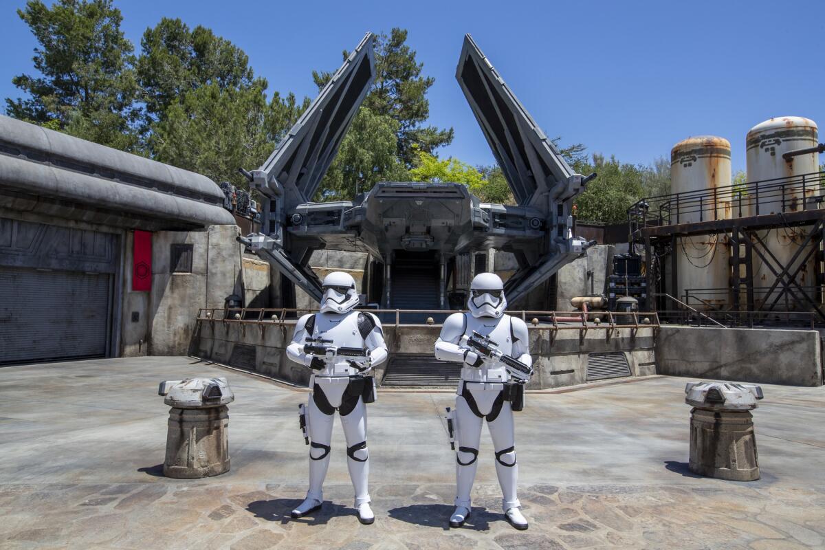 Stormtroopers patrol the First Order sector of the Black Spire Outpost where the Tie Echelon fighter ship is parked.