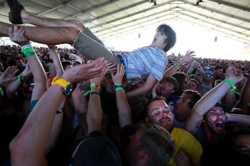 A fan crowd surfs during the Japandroids set.