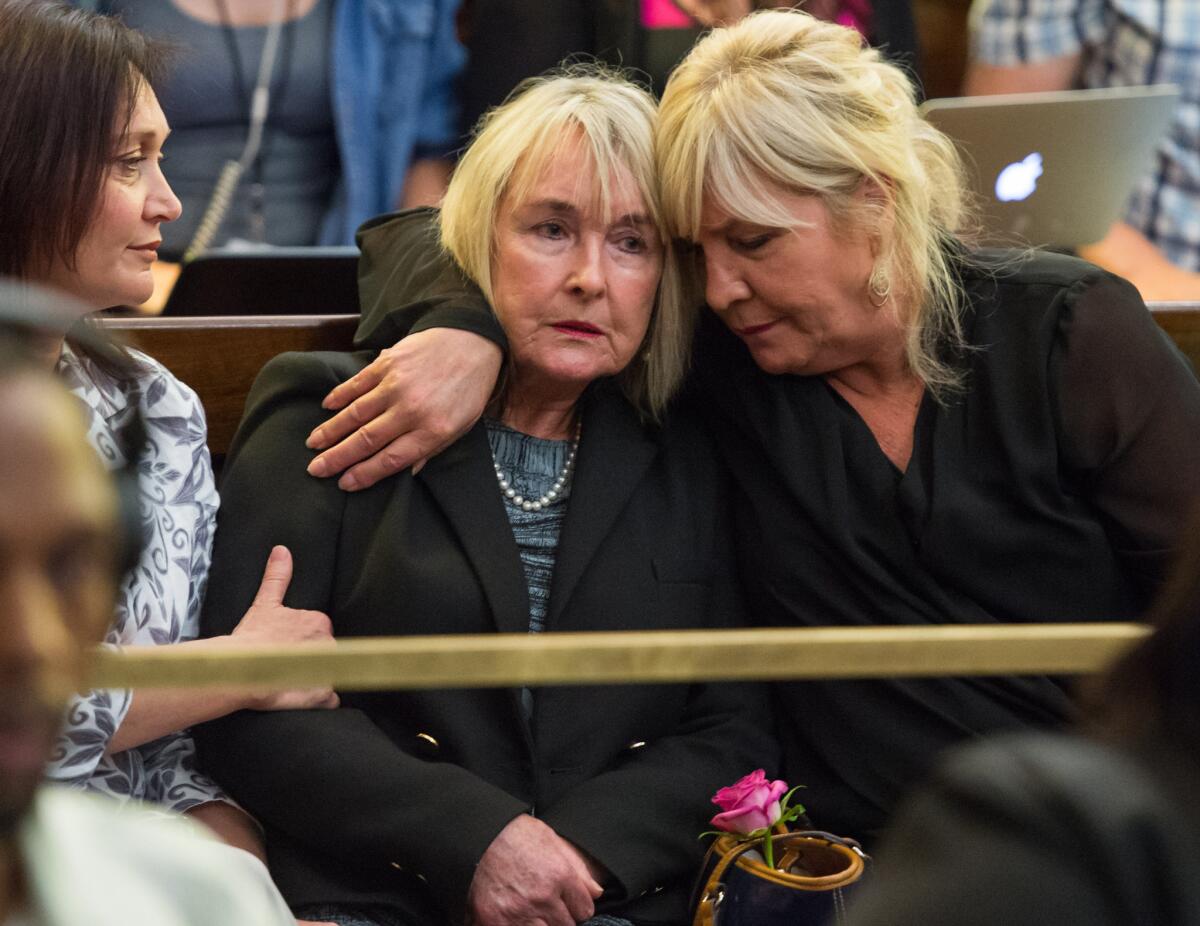 June Steenkamp, center, the mother of slaying victim Reeve Steenkamp, is comforted as an appeals court in Bloemfontein, South Africa, rules in the Oscar Pistorius case on Dec. 3.