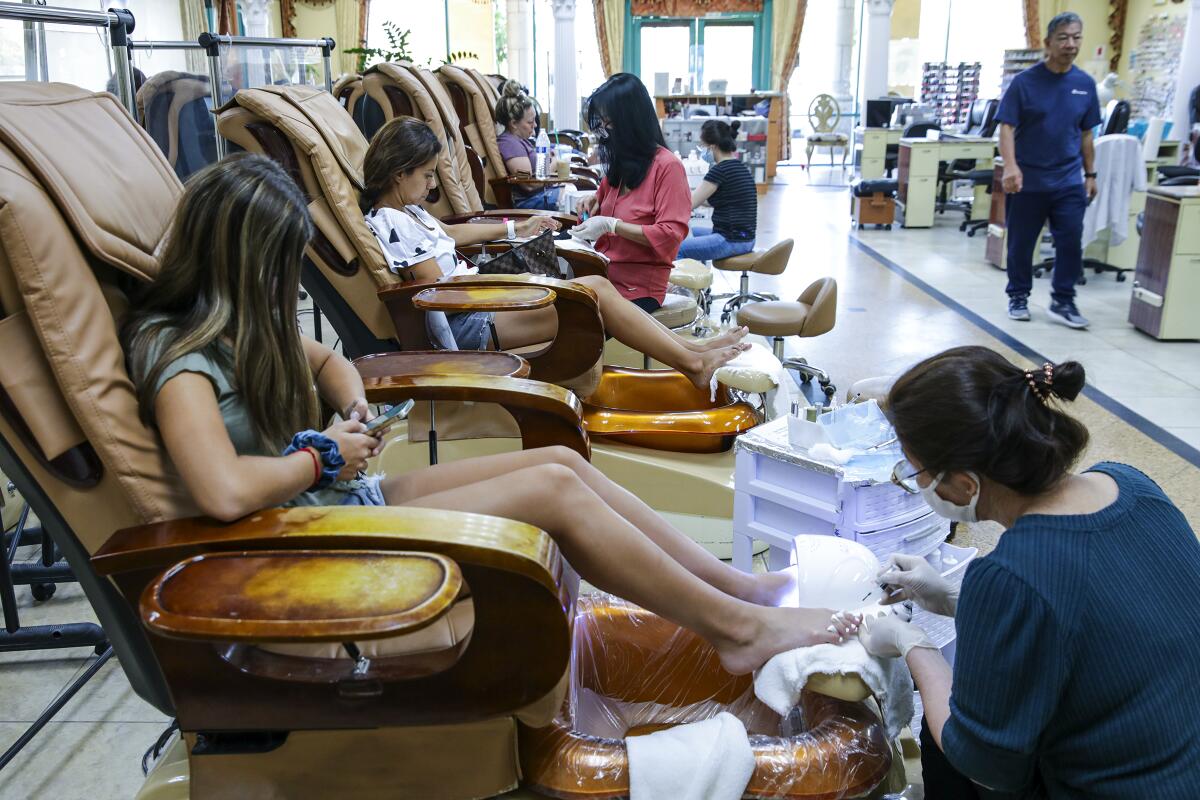 Customers getting pedicures and manicures at Queen Nails.