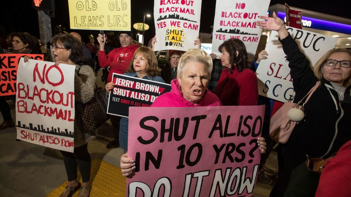 Diane Pinky Harmon, center, of Porter Ranch, joins residents of surrounding communities at the intersection of Rinaldi Street and Tampa Ave. in Porter Ranch to protest the continuing operation of the Aliso Canyon Storage Facility.