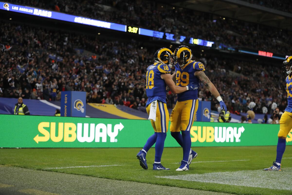 Rams receiver Cooper Kupp (18) is congratulated by tight end Tyler Higbee after scoring Oct. 27 against the Bengals at Wembley Stadium.