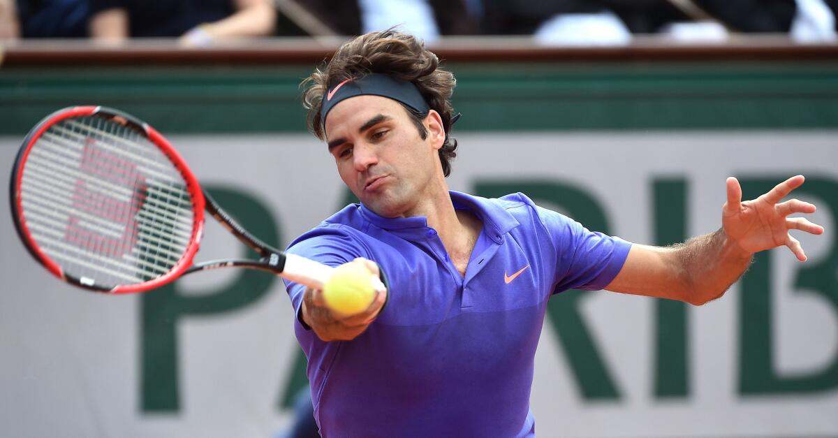 Roger Federer returns a shot against Damir Dzumhur during their third-round match at the French Open on Friday in Paris.