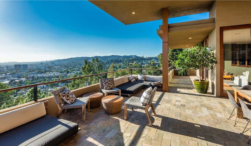 The hillside home includes three levels of decks, balconies and patios, as well as a swimming pool and spa.