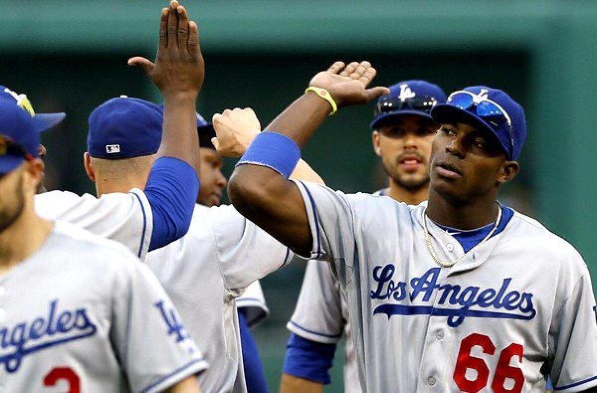 Dodgers right fielder Yasiel Puig (66) celebrates with teammates after defeating the Pittsburgh Pirates on Saturday.