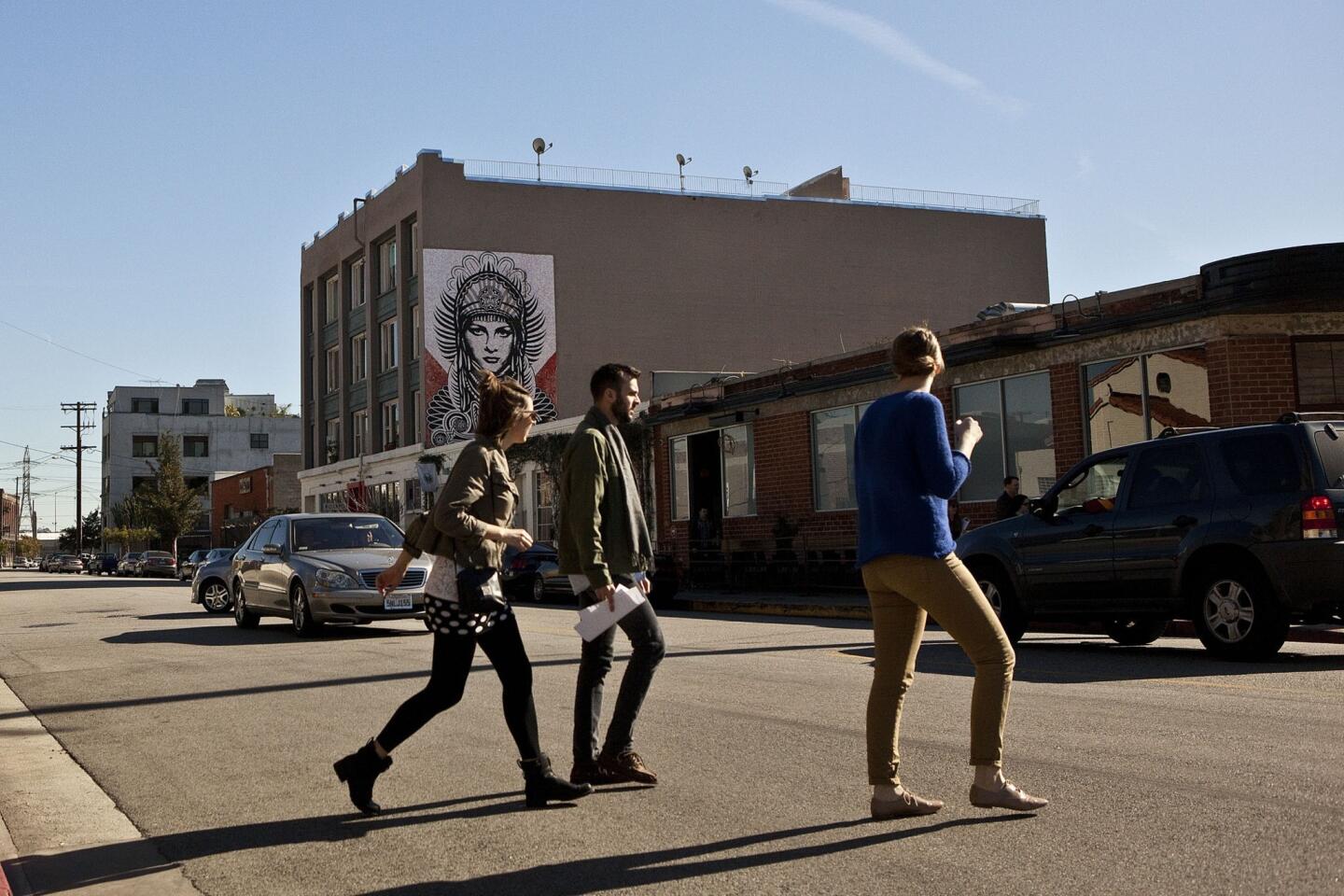 Pedestrians cross East Third Street. The neighborhood along the Los Angeles River east of downtown's Civic Center is drawing favorable comparisons to New York's meatpacking district, where trendy shops, restaurants, hotels and offices have taken over many industrial buildings that were strictly blue collar for decades.