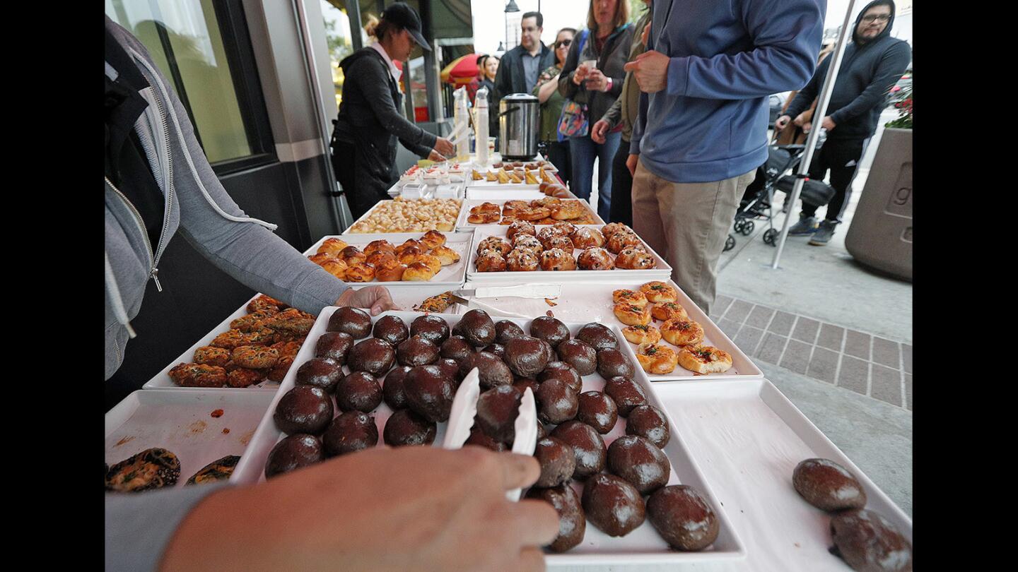 Chico buns being transferred from tray to tray at 85°C Bakery at Taste Walk Glendale on Wednesday, May 2, 2018.On and around South Brand Boulevard, 45 businesses and restaurants participated with the money earned from the event being used to support Glendale Arts' youth programs and the Alex Theatre.