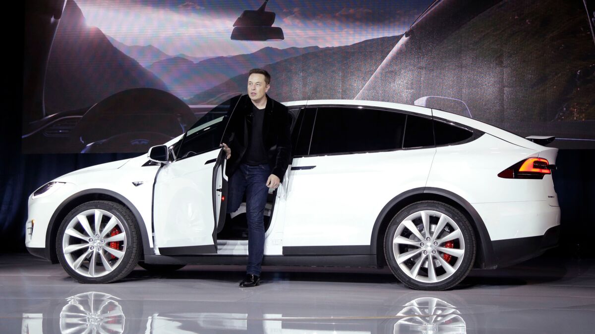 Elon Musk, CEO of Tesla Motors, introduces the carmaker's Model X at the company's manufacturing plant in Fremont, Calif., in September 2015. (Marcio Jose Sanchez /Associated Press)