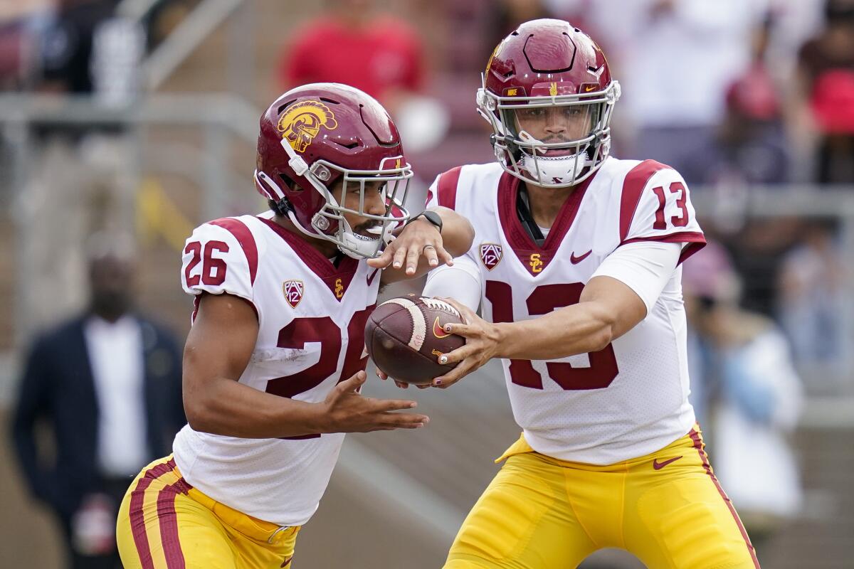 USC quarterback Caleb Williams hands the ball off to running back Travis Dye against Stanford on Sept. 10.