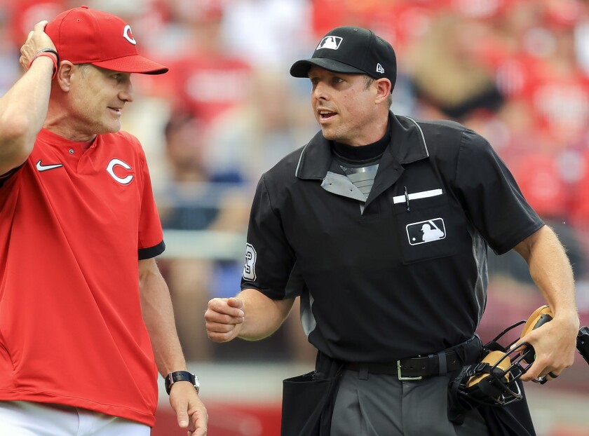 FILE - Cincinnati Reds' David Bell, left, talks with umpire Tripp Gibson, right, between batters during the first inning of a baseball game against the San Diego Padres in Cincinnati, July 1, 2021. Major League Baseball umpire Gibson grew up in Mayfield, Ky., and is back home this week after the town was devastated by a tornado last week. (AP Photo/Aaron Doster, File)