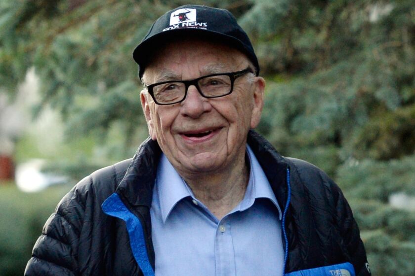 Rupert Murdoch's publishing company News Corp. said Thursday it would pay shareholders a semiannual cash dividend, its first since becoming a stand-alone company in 2013. Murdoch, who is chairman of News Corp., is pictured here in Sun Valley, Idaho, in July 2013.