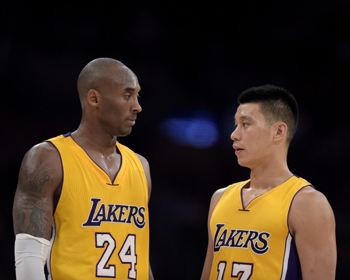 Kobe Bryant and Jeremy Lin take a moment to talk strategy during the Lakers' 112-106 loss to the Phoenix Suns on Tuesday at Staples Center.