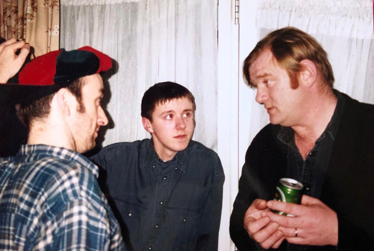 Three men at a 1990s house party