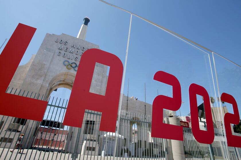 LOS ANGELES, CALIF. - SEP. 13, 2017. The Los Angeles Memorial Coliseum is framed by a plexiglass sign after the city was officially awarded the rights to host the 2028 Olympic Games on Wednesday, Sep. 13, 2017. (Luis Sinco/Los Angeles Times)
