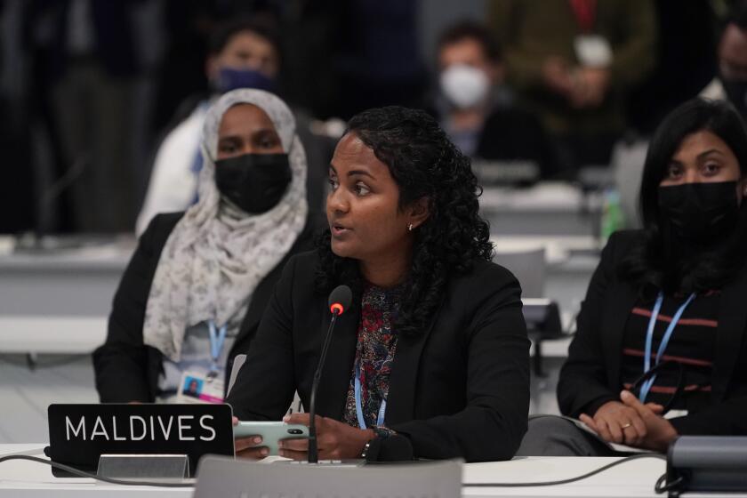 Aminath Shauna, Maldives' Minister of Environment, Climate Change and Technology speaks during the closing plenary session at the COP26 U.N. Climate Summit, in Glasgow, Scotland, Saturday, Nov. 13, 2021. Government negotiators from nearly 200 countries have adopted a new deal on climate action after a last-minute intervention by India to water down the language on cutting emissions from coal. (AP Photo/Alberto Pezzali)