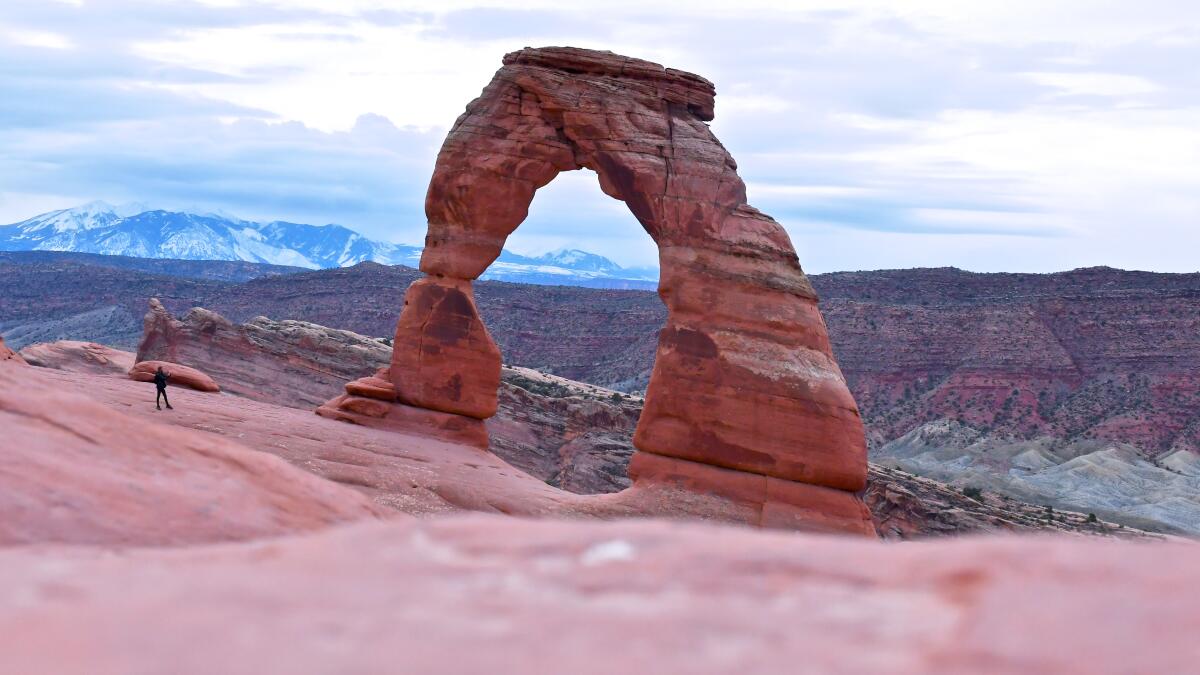 A hiker nears Delicate Arch at the Arches National Park in Utah.