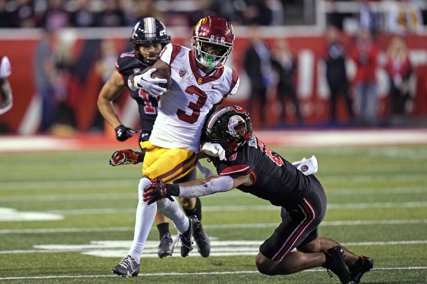 Utah safety Cole Bishop (8) tackles Southern California wide receiver Jordan Addison (3) during the first half of an NCAA college football game Saturday, Oct. 15, 2022, in Salt Lake City. (AP Photo/Rick Bowmer)