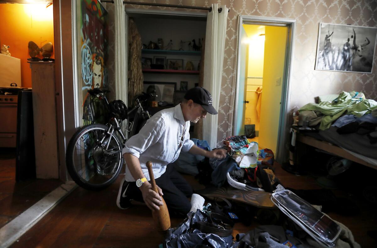 Peter James, 62, unpacks and organizes his new apartment in Los Angeles on March 19.