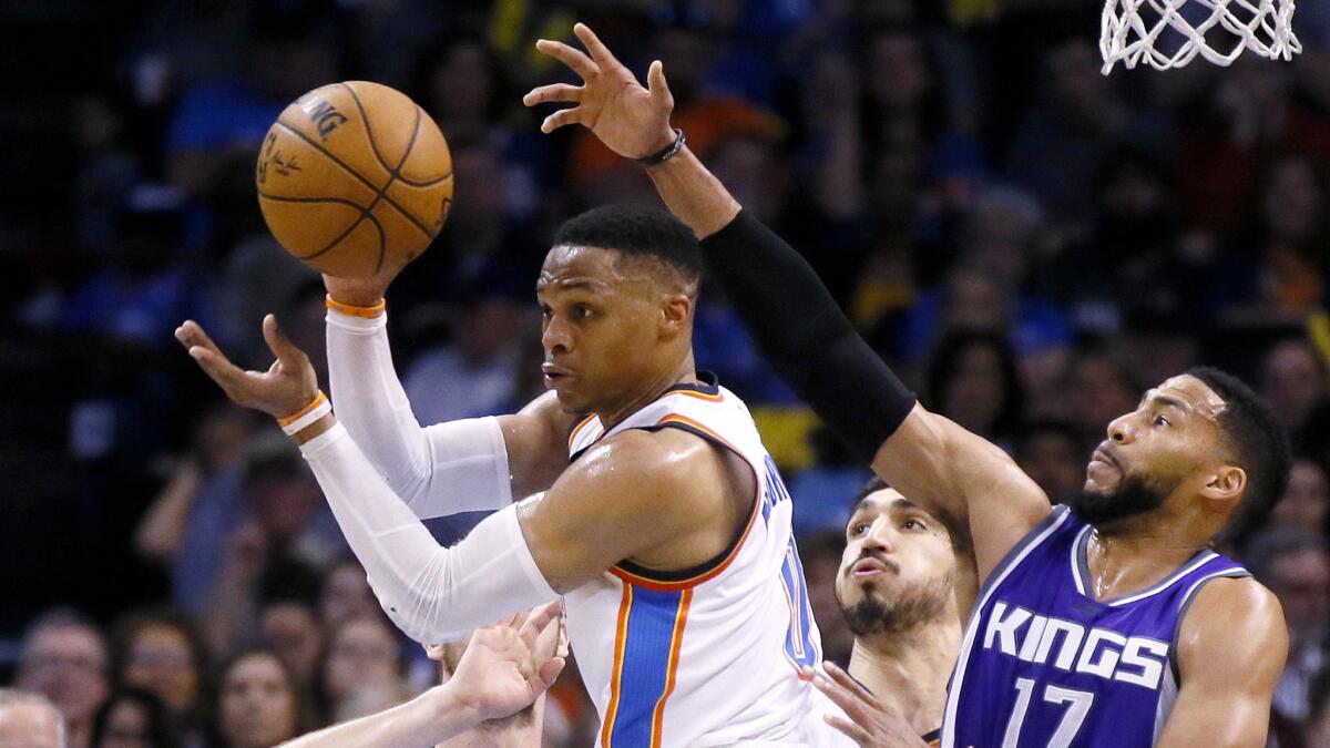 Thunder guard Russell Westbrook passes after driving into traffic in the lane during the third quarter Saturday night.