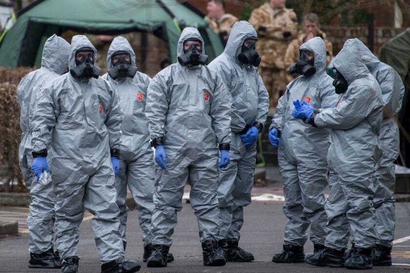 SALISBURY, ENGLAND - MARCH 11: Military personnel wearing protective suits remove a police car and other vehicles from a public car park as they continue investigations into the poisoning of Sergei Skripal on March 11, 2018 in Salisbury, England. Sergei Skripal who was granted refuge in the UK following a 'spy swap' between the US and Russia in 2010 and his daughter remain critically ill after being attacked with a nerve agent. (Photo by Chris J Ratcliffe/Getty Images) *** BESTPIX *** ** OUTS - ELSENT, FPG, CM - OUTS * NM, PH, VA if sourced by CT, LA or MoD **