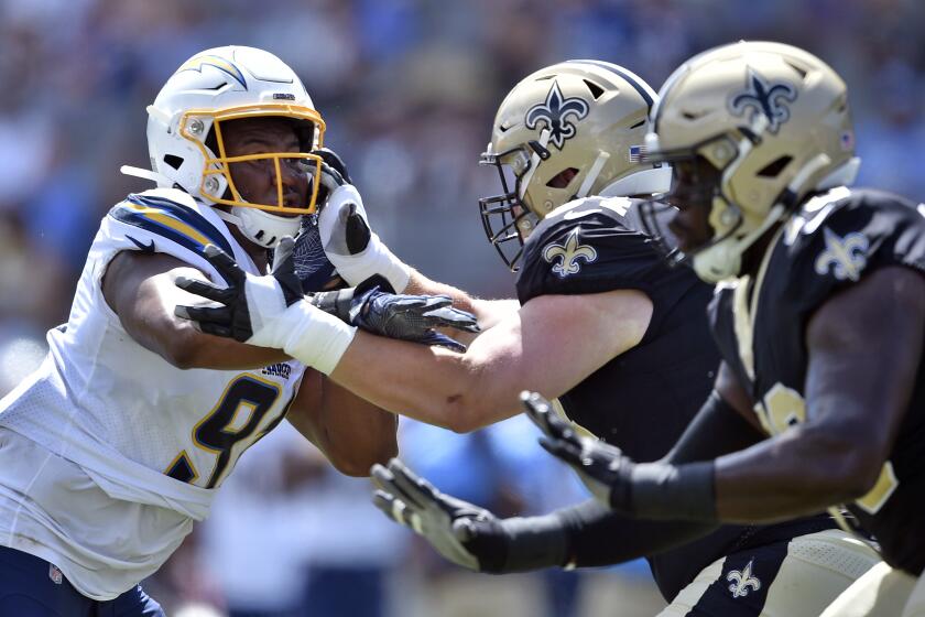 Los Angeles Chargers defensive tackle Jerry Tillery, left, works against the New Orleans Saints during the first half of a preseason NFL football game Sunday, Aug. 18, 2019, in Carson, Calif. (AP Photo/Kelvin Kuo )