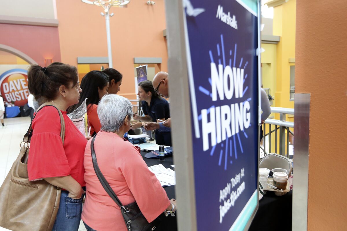 People wait to inquire about job openings with Marshalls in Miami