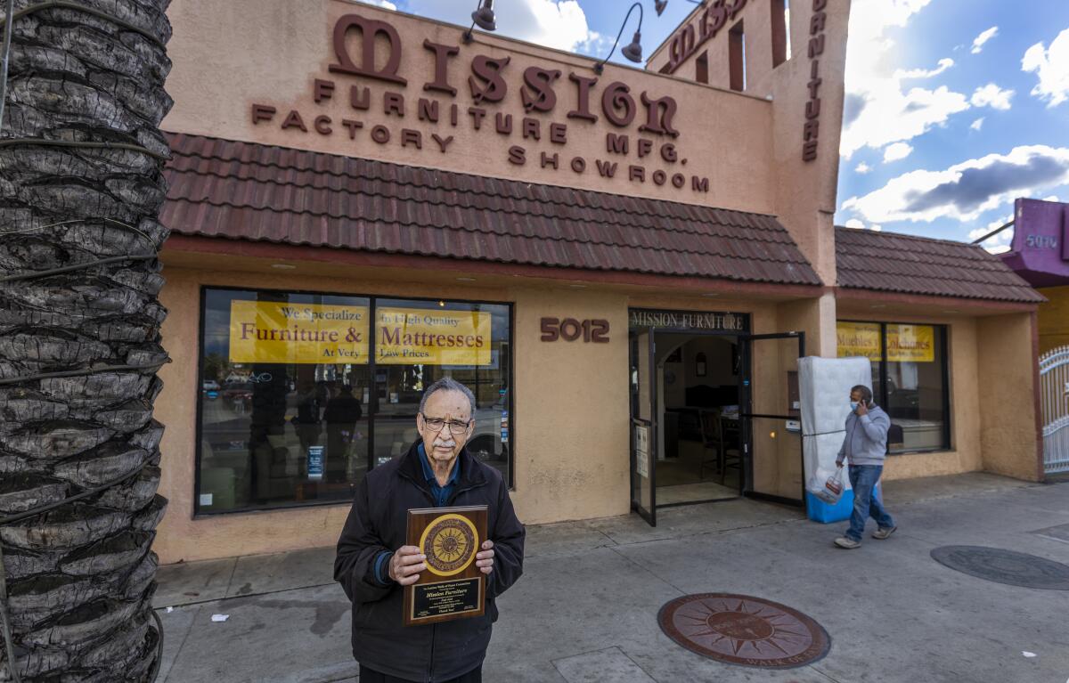 Cecilio Acevedo, owner of Mission Furniture Mfg., holds a plaque from the Latino Walk of Fame
