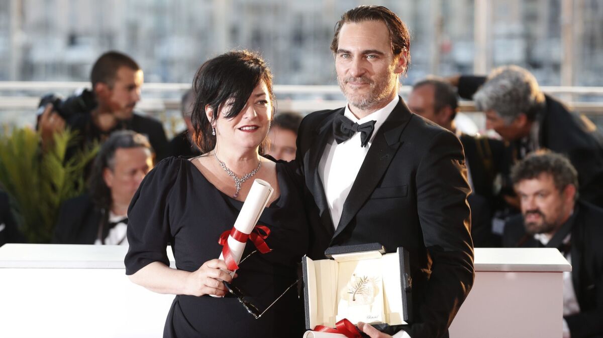 Director Lynne Ramsay, left, with her joint best screenplay award and actor Joaquin Phoenix with his best actor award, both for the film 'You Were Never Really Here," following the awards ceremony at the 70th Cannes Film Festival.