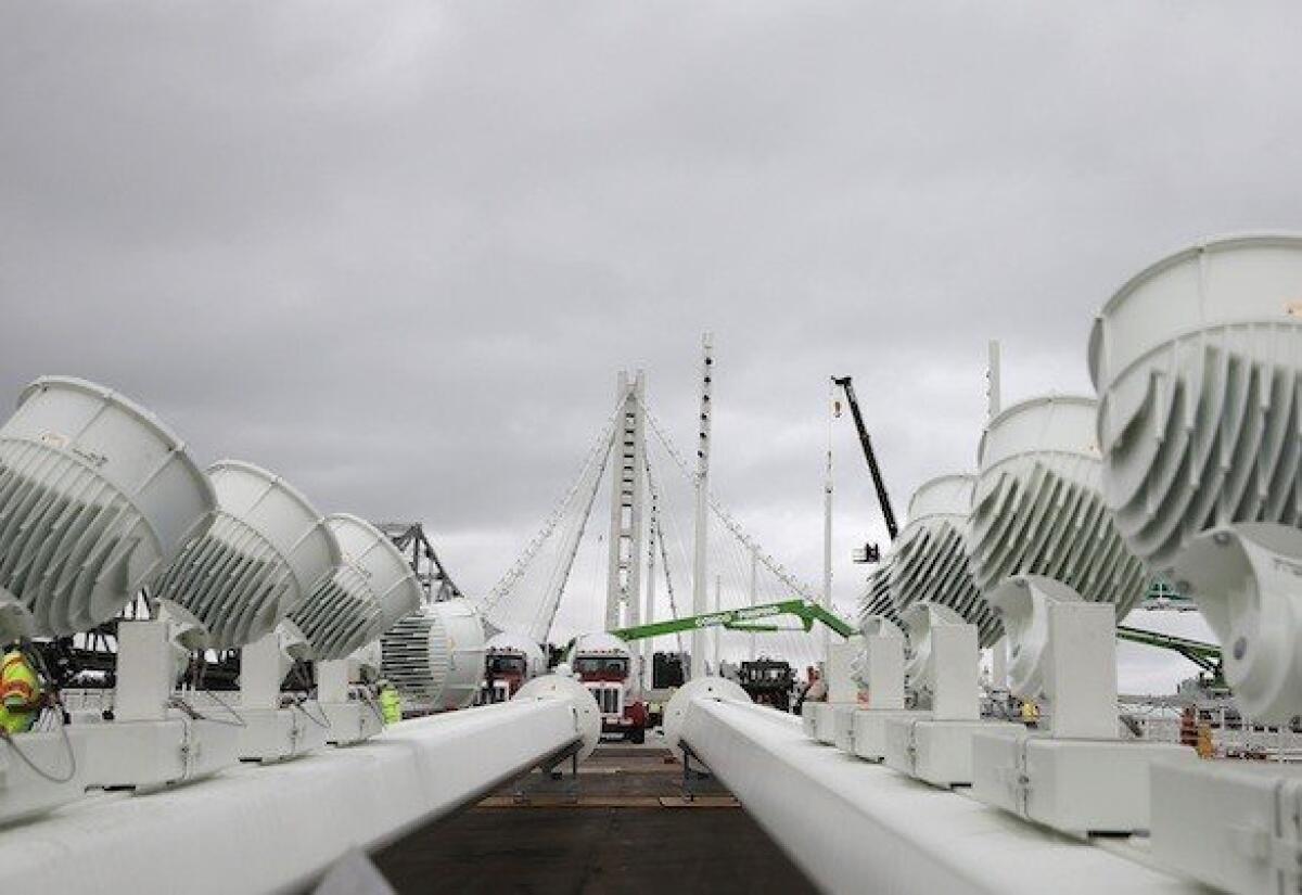 Two light poles sit on the deck of the new Bay Bridge earlier this month. The bridge has been under construction since 2002, with an estimated price tag of $6.4 billion.