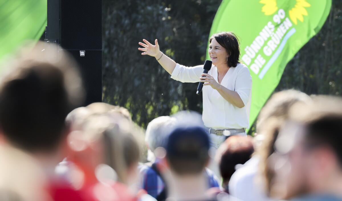 The candidate for chancellor of the German Green party, Annalena Baerbock, speaks during an election campaign event in Halle near Leipzig, Germany, Wednesday, Sept. 8, 2021. Climate change is among the top concerns for Germans going into this year's national election that will determine who replaces Angela Merkel as Chancellor. But while voters admit they are worried about the state of the planet, especially after last the deadly floods that hit Germany in July, many fear the cost of backing the environmentalist Green party that's campaigned strongest for meeting the Paris climate accord's goals. (Jan Woitas/dpa via AP)