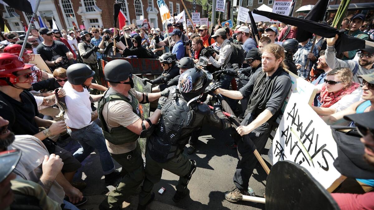 Neo-Nazis, white nationalists and members of the alt-right, at left, clash with counterprotesters last year in Charlottesville, Va.