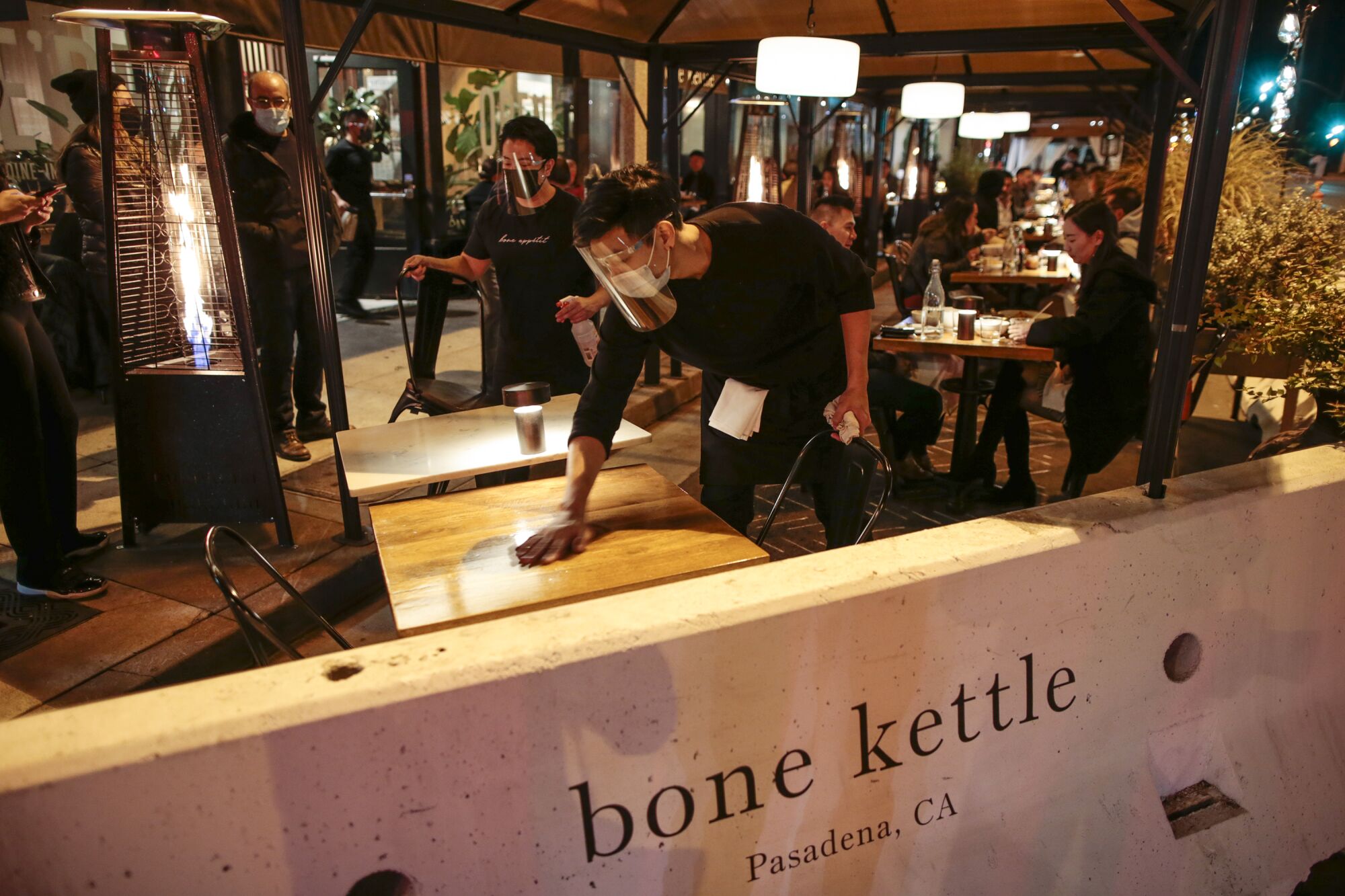 Tables are sanitized at Bone Kettle in Pasadena.