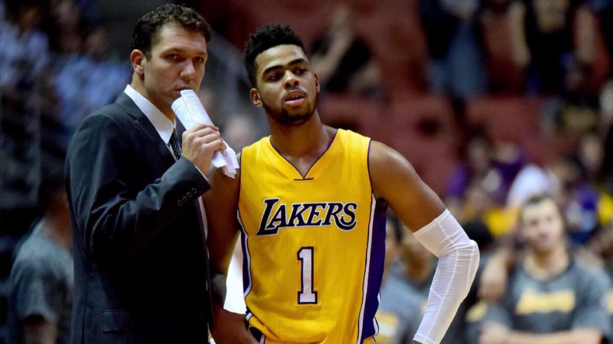 Lakers Coach Luke Walton and guard D'Angelo Russell talk during a preseason game against the Phoenix Suns on Oct. 21.
