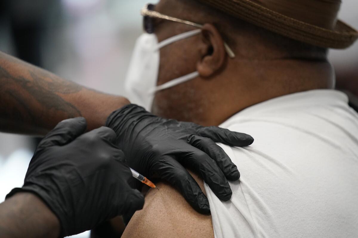 A man receives a COVID-19 vaccine