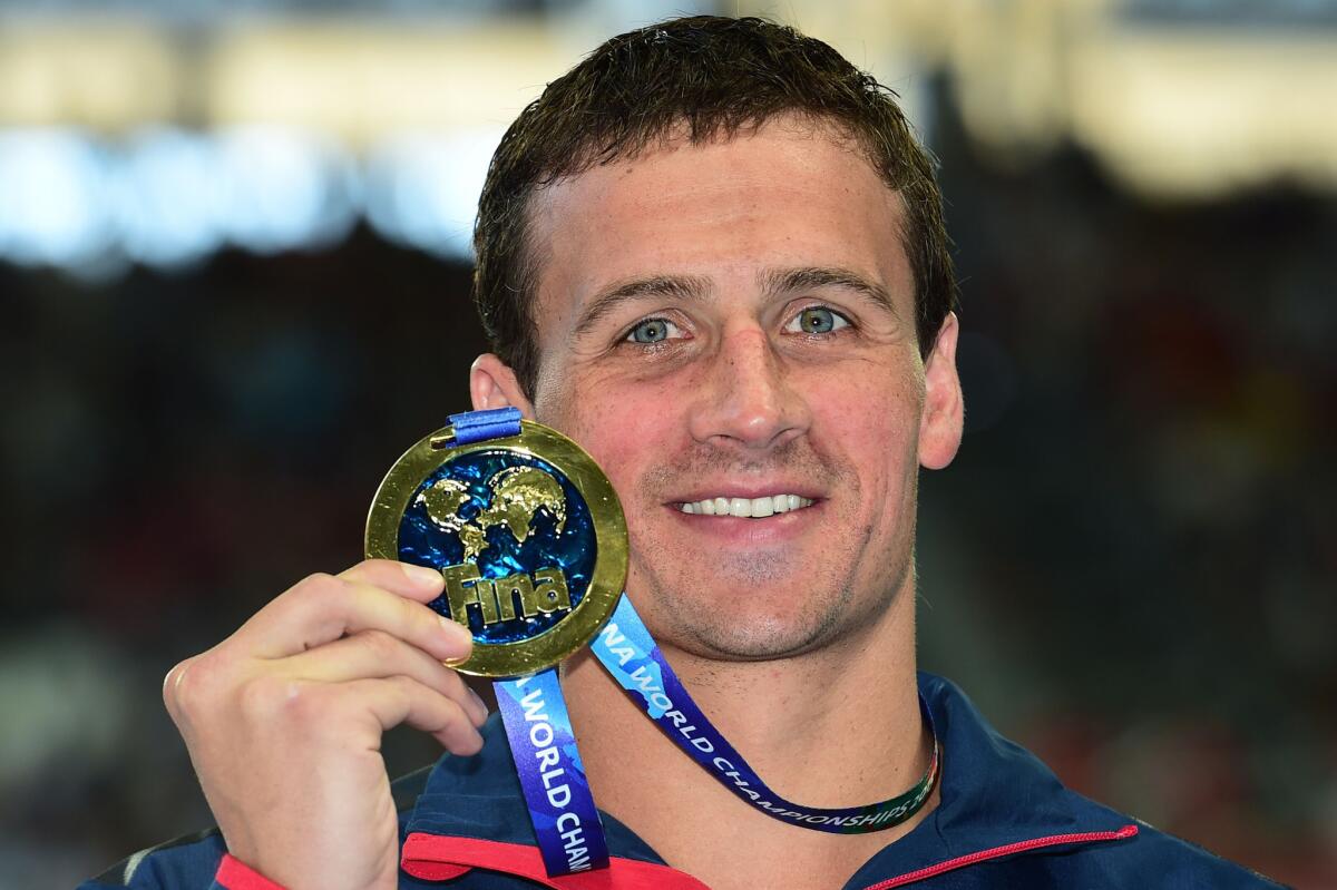 Ryan Lochte of the United States poses with his gold medal after winning the men's 200m individual medley for the fourth consecutive time at the FINA World Championships.