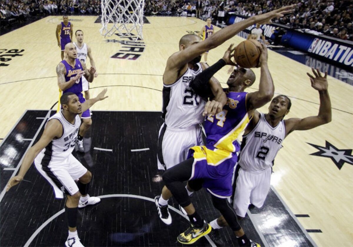 Spurs big man Tim Duncan blocks a shot by Lakers guard Kobe Bryant during a game earlier this season.